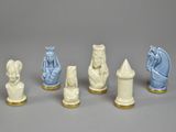 five chess pieces with different designs on them