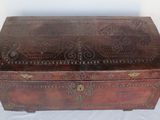 an old wooden box with a decorative design on it