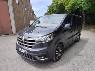 the grey van is parked on the side of the road