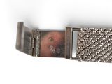 an image of a close up of a metal belt on a white surface