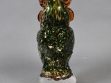 a glass owl figurine sitting on top of a clear base
