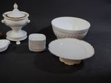 a lot of white plates and bowls on the table