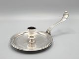 a silver plate with a handle and a handle on it