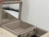 a person opening a suitcase that is sitting on the floor