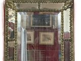 a mirror hanging on the wall with pictures on the wall