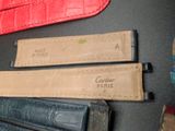 three pieces of leather on a table with a pair of scissors