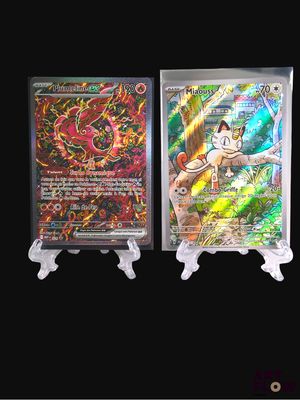 two pokemon trading cards on display on a black background