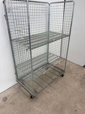 wire mesh shelf with four shelves on wheels in a room