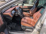 the interior of a car with leather seats and a steering wheel