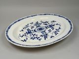a blue and white plate with a floral design on it