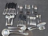 a lot of forks and spoons that are on the table