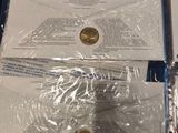 two envelopes are wrapped in plastic and sitting on top of a table