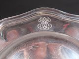 a silver plate with a decorative design on it