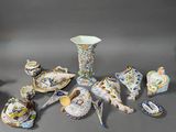 many different pieces of porcelain sitting on a table