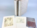 three books with drawings on them sitting on top of a table
