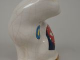 porcelain figurine of a white cat with a blue and red design