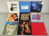 various album covers of various albums on display on a glass table