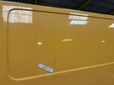 a close up of a yellow car with a tag on it
