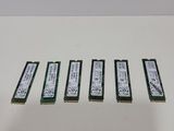 four memory modules are sitting on a table next to each other