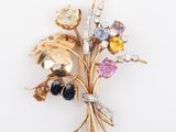 an image of a brooch with a bunch of different colored stones