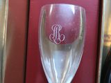 a wine glass and a bottle of wine in a box