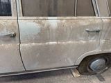 a dirty car that is parked on the side of the road