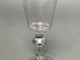 a wine glass that is sitting on top of a table