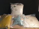 many bags of pillows and pillows on a table