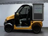 a small yellow vehicle with a box on the back of it