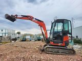 a small excavator that is sitting in the dirt