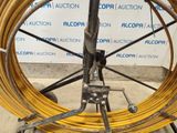 a close up of a yellow hose on a cart