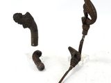 two pieces of metal that have been placed on a white surface