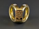 an image of a gold ring with the words made in france written on it