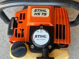 a close up of a chainsaw sitting on the ground