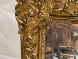 a mirror that is sitting on a table in front of a chair
