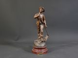 bronze statue of a woman with a dog on a marble base