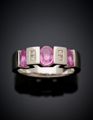 a close up of a pink sapphire and diamond ring