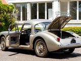 a silver sports car parked in front of a house