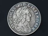 a close up of a silver coin with a woman ' s head on it