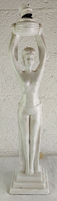 a statue of a woman holding a bowl on her head