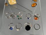 clear acrylic display case with various rings and rings on it