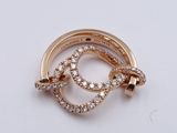 an image of a gold and diamond broochle on a white surface