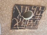 a close up of a piece of pottery with a hole in it
