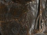 a statue of a man sitting on top of a marble base