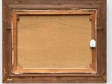 an old picture frame with a piece of paper hanging on the wall