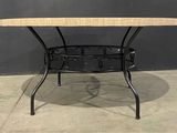 an image of a table with a marble top on a concrete floor
