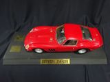 a close up of a red toy car on a black surface