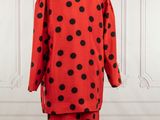 a red and black polka dot print suit on a mannequin mannequin