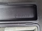 a black box with a pen in it on a table