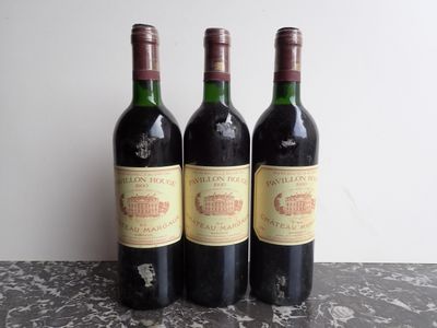 three bottles of wine sitting on top of a table next to each other